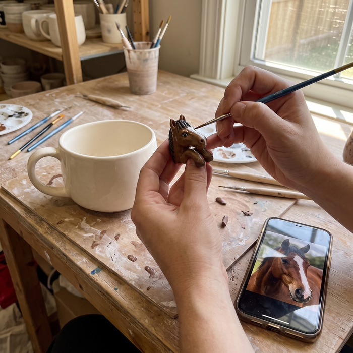 2 · A person sculpts her